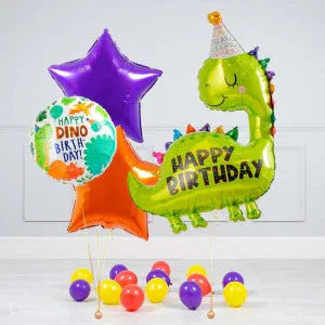 Colorful dinosaur-themed birthday balloons with star shapes and colorful round balloons on floor