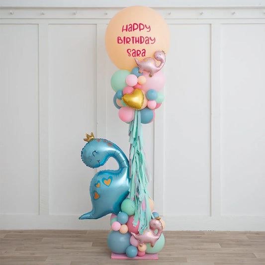 Dinosaur-themed birthday balloon arrangement with custom message Happy Birthday Sara in pastel colors