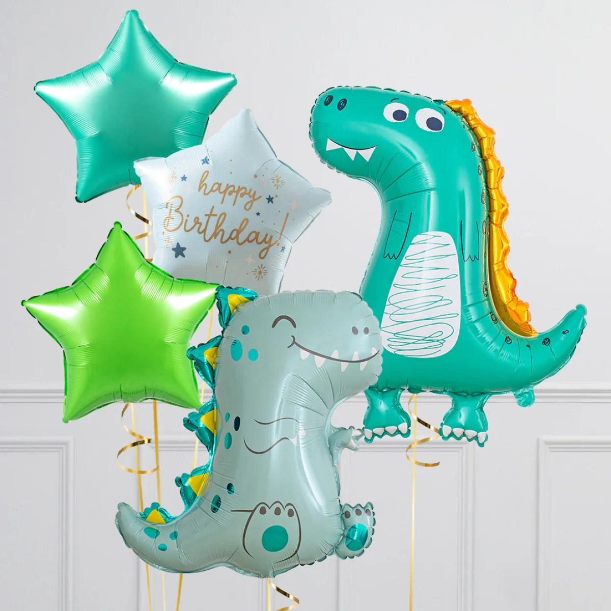 Birthday balloons set featuring two cartoon dinosaur shapes and three star-shaped balloons in green and white