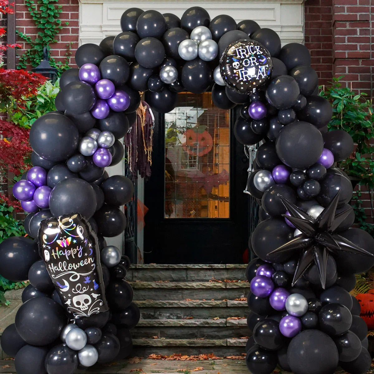 Halloween balloon arch with black, purple, and silver balloons, featuring 'Happy Halloween' and 'Trick or Treat' balloons