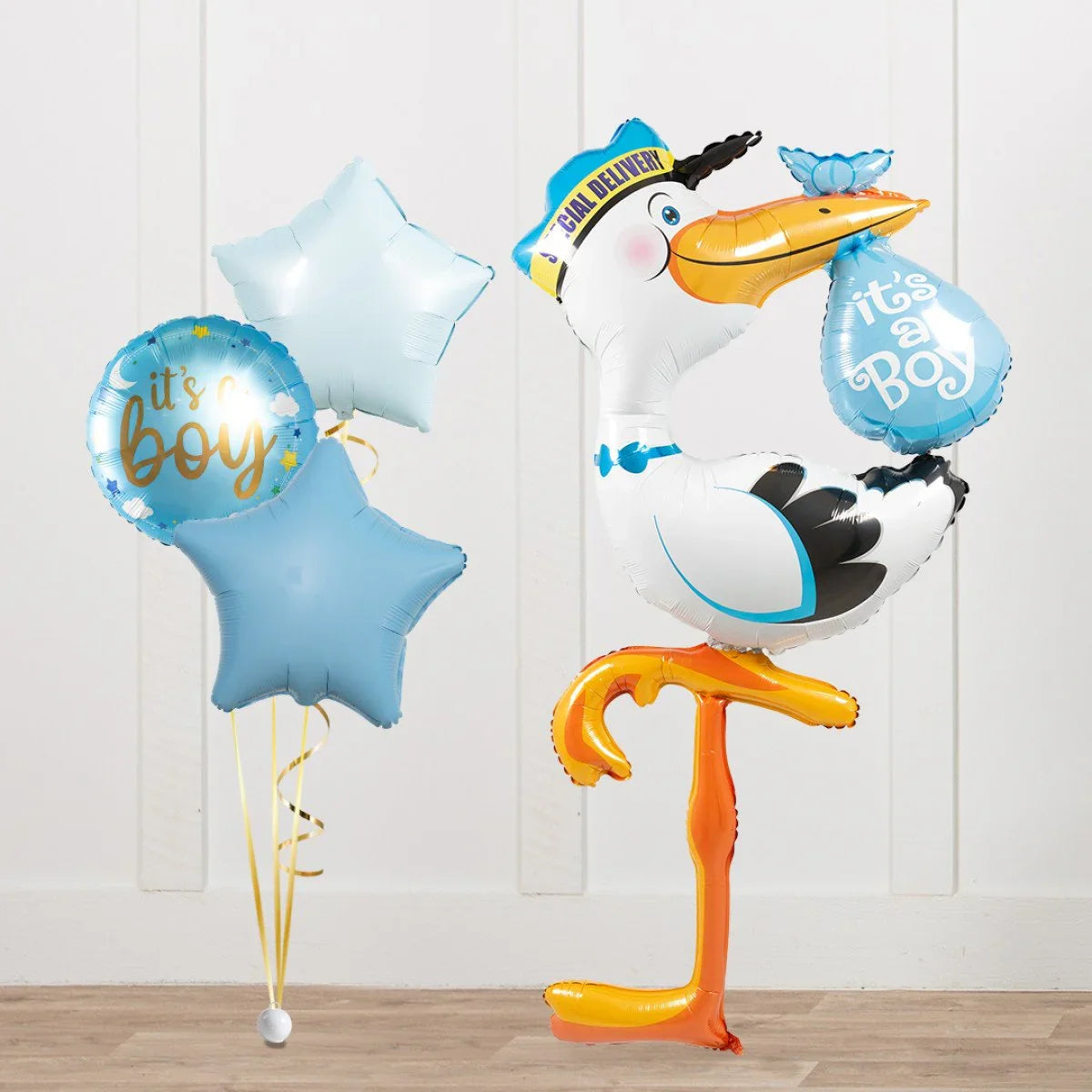 Blue and white star and round balloons with it's a boy text, and a stork balloon holding an it's a boy bundle