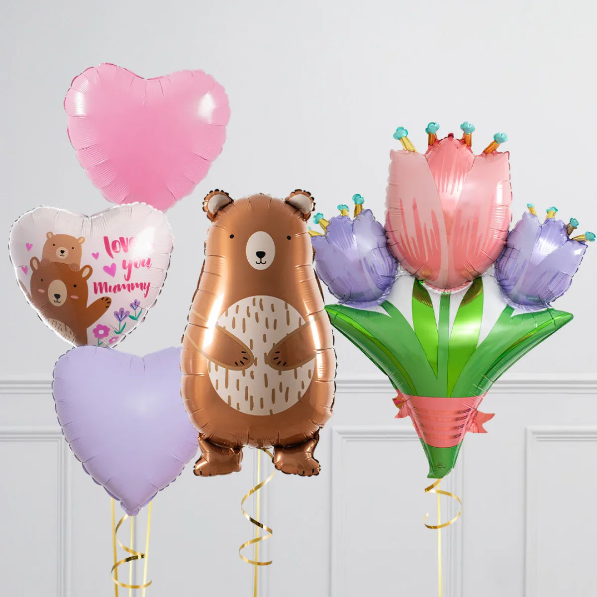 Heart-shaped pink and purple balloons with bear and flower foil balloons saying love you mummy