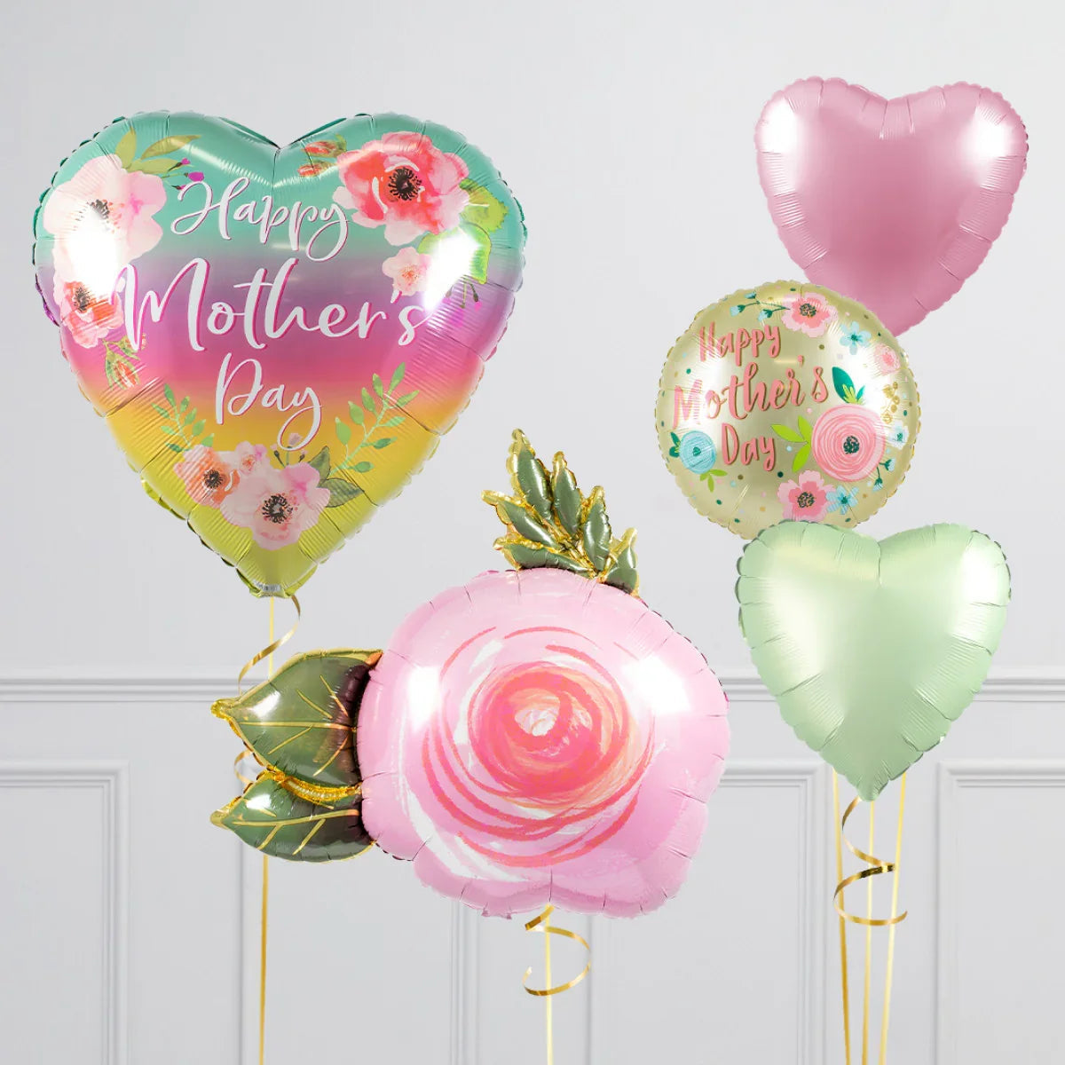 Colorful Happy Mother's Day foil balloons with floral and heart designs in room