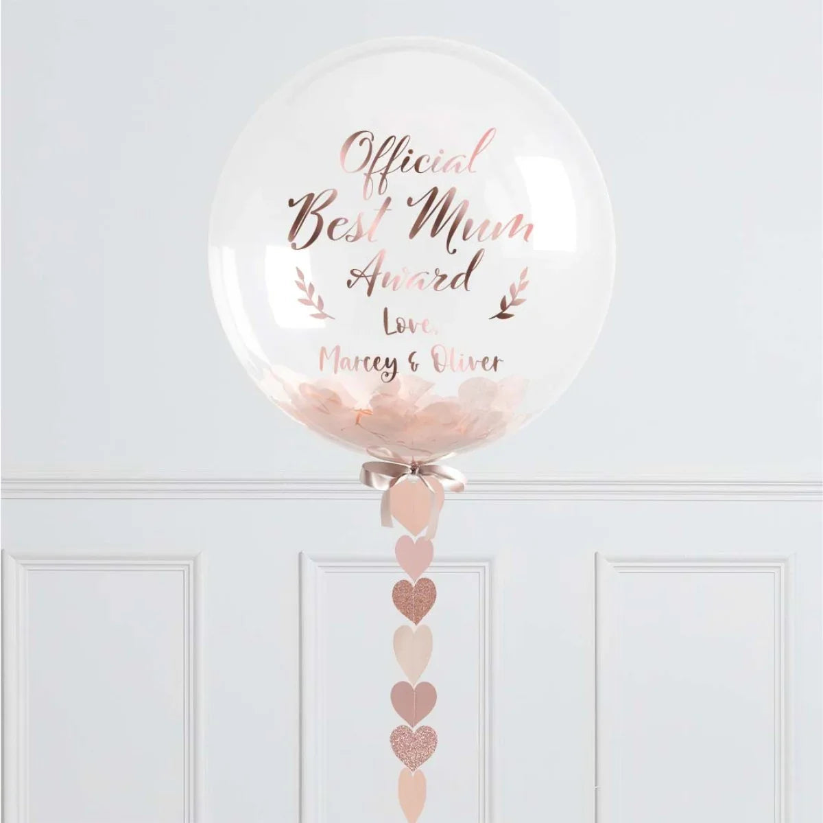 Clear balloon with rose gold text "Official Best Mum Award" and pink heart decorations
