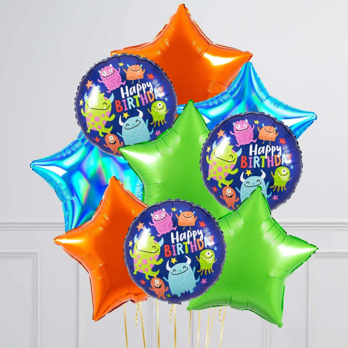Colorful helium balloons with happy birthday monster design and star-shaped balloons in orange, green, blue