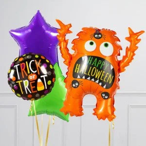 Halloween balloons including orange monster with Happy Halloween text, purple star, green star, and Trick or Treat round balloon