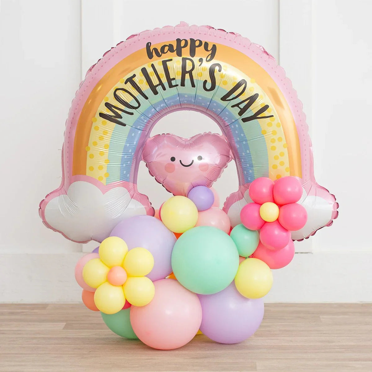 Pastel rainbow-shaped balloon with happy face heart and flower-shaped balloon bouquet for Mother's Day