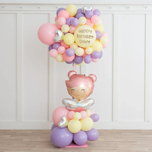 Pastel balloon bouquet with pink, purple, yellow balloons and Happy Birthday Dolly message