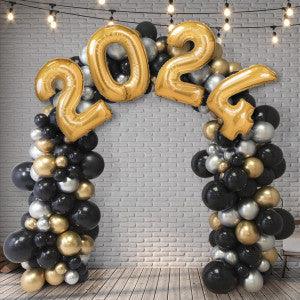 Elegant black, gold, and silver balloon arch with large gold 2024 number balloons and string lights