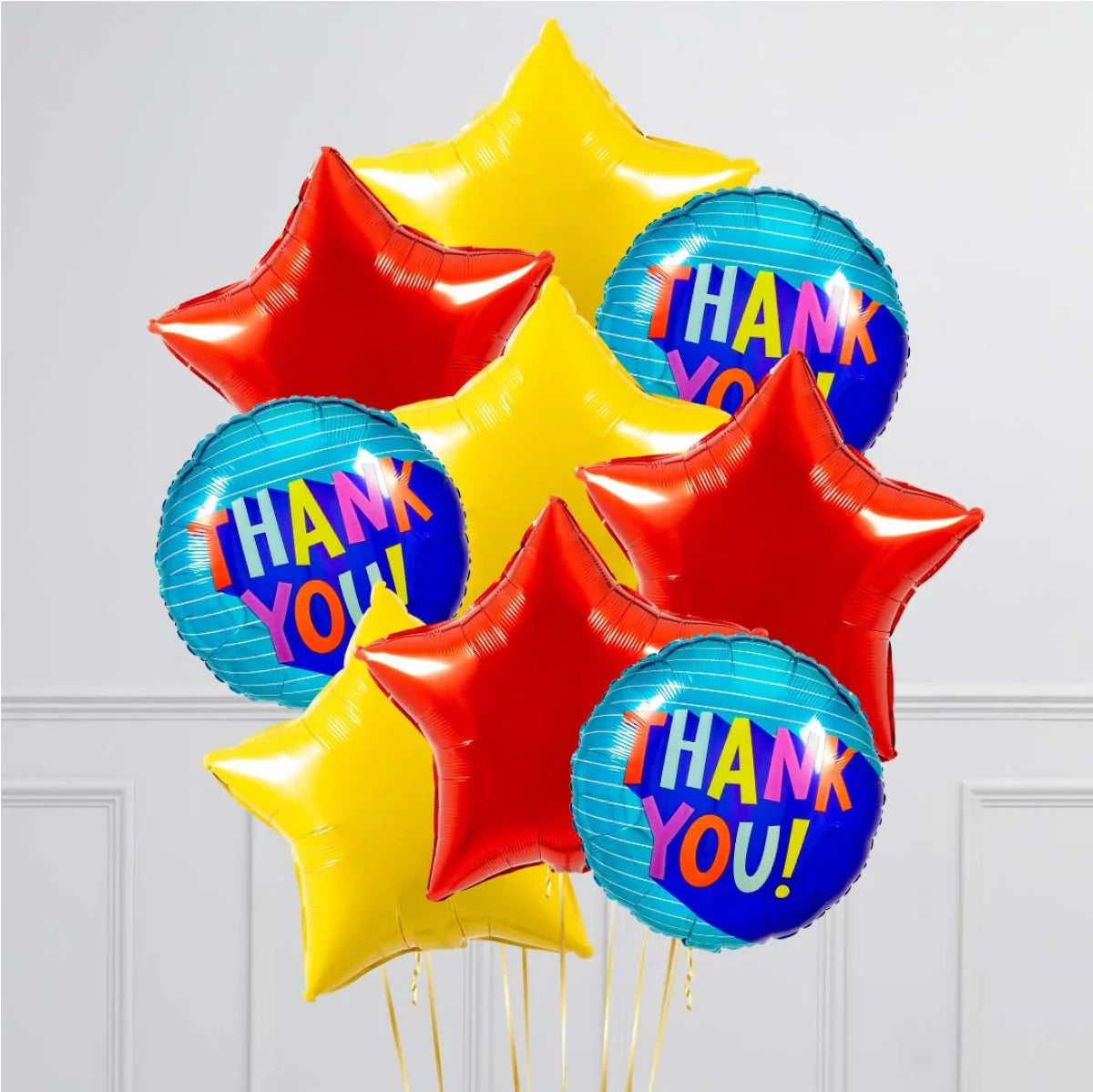 Cluster of colorful star-shaped and round thank you balloons in red, yellow, and blue