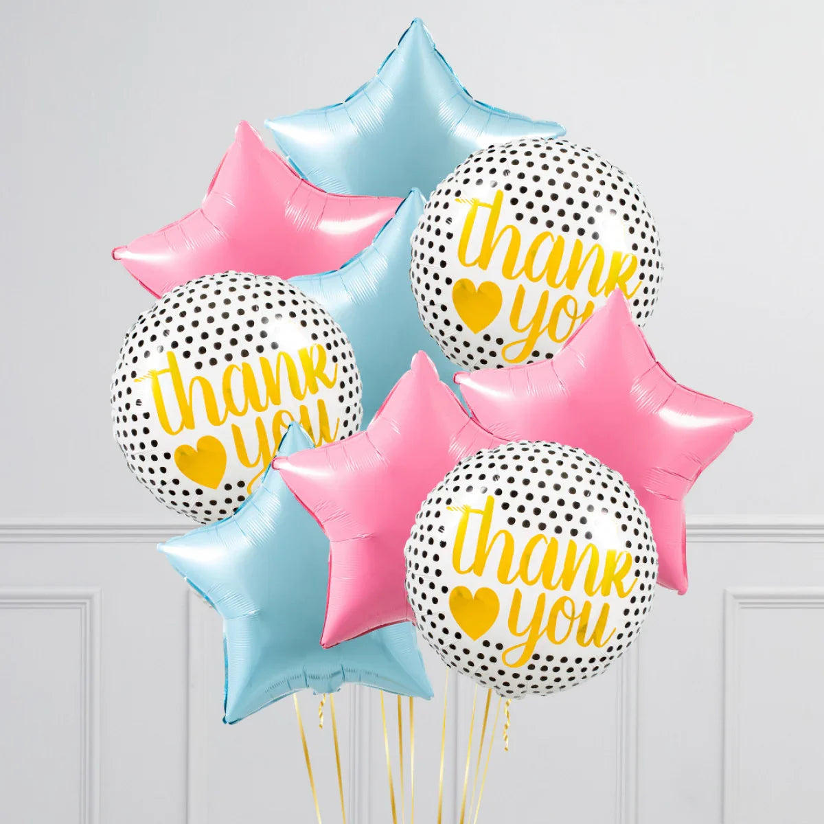 Thank you balloons bouquet with black polka dots, yellow text, pink and blue star-shaped balloons