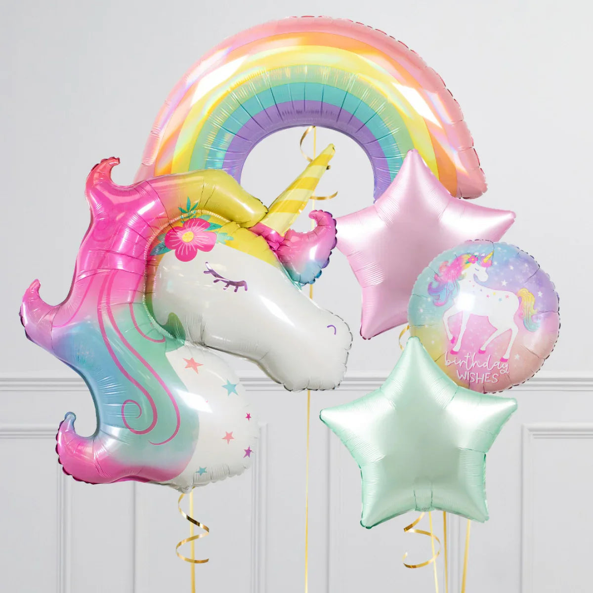 Colorful unicorn head balloon with rainbow, pastel star balloons, and birthday wishes round balloon